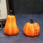 Tall and medium pumpkin lights showing their illuminated crackle finish